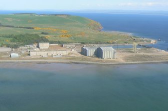 Oblique closer aerial view of Nigg oil platform fabrication yard, Nigg ferry terminal and North Sutor, looking E.