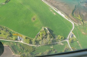 Closer almost vertical aerial view of Skelbo Castle and shore line of Loch Fleet, East Sutherland, looking NW.