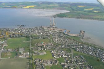 Oblique aerial view of Invergordon with the Cromarty Firth, Harbour and Balblair on the Black Isle, looking S.