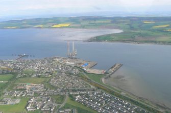 Oblique aerial view of Invergordon with the Cromarty Firth, Harbour and Balblair on the Black Isle, looking S.