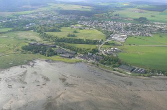 An oblique view of Dalmore distillery, the N shore of the Cromarty Firth and Alness, looking NW.