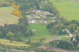 An oblique aerial view of the western extremity of Muir of Ord in Rosshire, looking W.