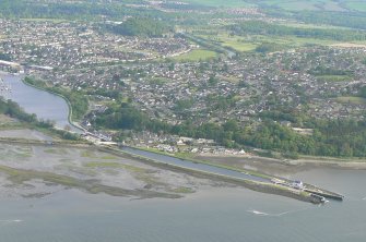 An oblique aerial view of the N end of the Caledonian canal where it enters the Beauly Firth, with Inverness in the background, looking S.