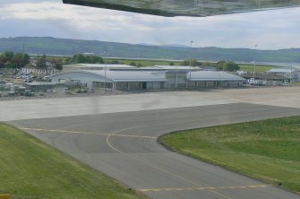 An oblique aerial view of the terminal building at Dalcross Airport under construction, E of Inverness, looking NE.