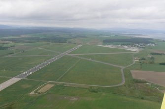 An oblique aerial view of Dalcross Airport outside Inverness, looking W.