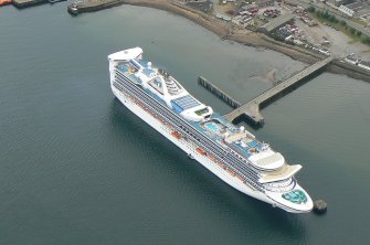 Oblique aerial view of a cruise ship at East pier, Invergordon, Cromarty Firth, looking N.