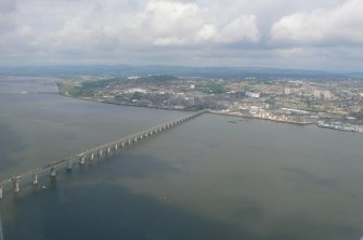 Oblique aerial view of western Dundee and the N sections of the Tay Road Bridge and Tay Bridge, with Dundee Airport beyond, looking NW.