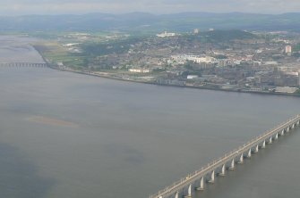 Oblique aerial view of western Dundee, part of the Tay Road Bridge and the N section of the Tay Bridge, with Dundee Airport beyond, looking NW.