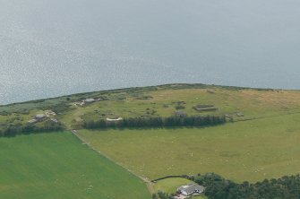 An oblique aerial view of military camp, coast battery and gun emplacements on the North Sutor, Cromarty Firth, looking S.