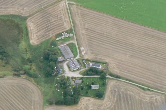 An almost vertical aerial view of Gilchrist church and burial ground, Muir of Ord, Black Isle, looking E.