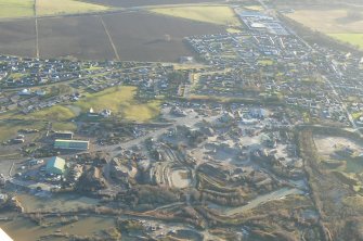 Oblique aerial view of the east part of the town of Alness, Easter Ross, looking S.