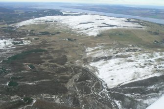 General oblique aerial view of the middle part of Strath Sgitheach, north of Dingwall, Ross-shire, with Cnoc a Breacaich in the middle distance and the Cromarty Firth and its Sutors in the distance, looking NE.