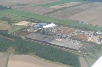 Oblique aerial view of the Norbord factory, Morayhill, Inverness, looking ESE.