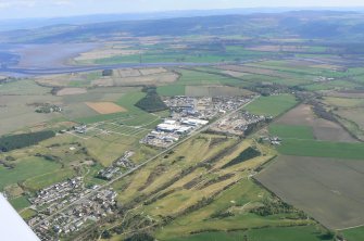 General oblique aerial view of Muir of Ord, looking SE.