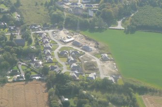 Aerial view of W end of village, Kirkhill, near Beauly, looking SE.