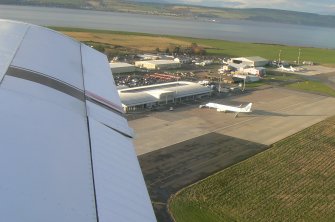 An oblique aerial view of Inverness Airport, Dalcross, Inverness, looking NW.