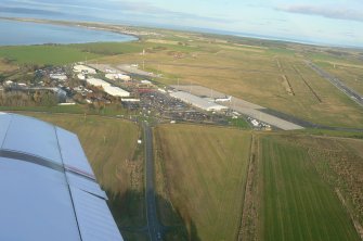 An oblique aerial view of Inverness Airport, Dalcross, Inverness, looking NE.