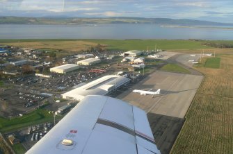 An oblique aerial view of Inverness Airport, Dalcross, Inverness, looking NW.