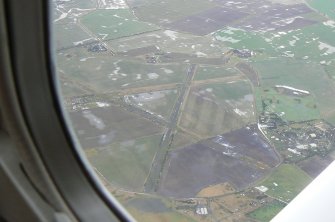An oblique aerial view of the former military airfield in the parish of Fearn on the Tarbat Peninsula, looking W.