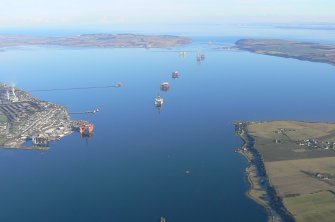 Aerial view of Invergordon, harbour, oil tanks and oil rigs, near Dingwall, Easter Ross, looking E.