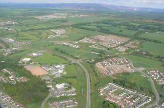 Aerial view of building development around the Leys Roundabout on the Inverness Southern Distributor Road (A8082), looking E.