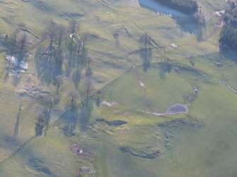 Oblique aerial view of settlement remains S of Essich Mor, near Inverness, looking S.