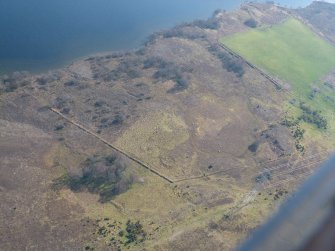 Aerial view of Torr an Daimh prehistoric settlement, Loch Duntelchaig, S of Inverness, looking S.