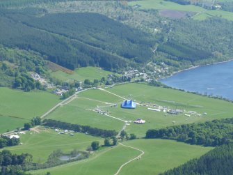 Close up aerial view of Dores Village (and Rock Ness Music Festival) at the north end of Loch Ness, looking SE.