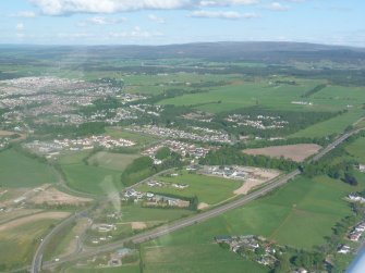 Aerial view of the A9 main road between Inverness, and Perth with Inverness beyond, looking N.