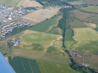 Aerial view of Lower Ardnagrask, The Cairns and Muir of Ord Industrial Estate with various cropmarks, Black Isle, looking SE.