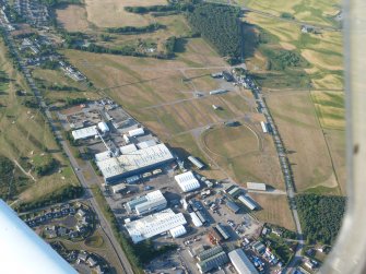 Aerial view of Mannsfield Showground and Gilchrist cropmark fort site, Muir of Ord, Black Isle, looking NNE.