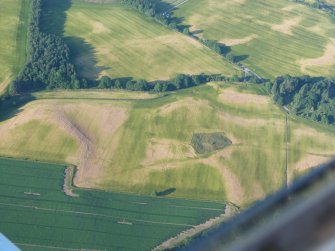 Aerial view of Tarradale Enclosure/ Fort, Enclosure and Barrow cemetery cropmarks, Black Isle, looking NE.
