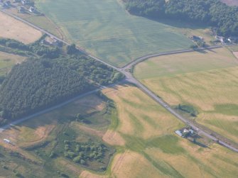 Aerial view of Gilchrist and cropmarks S of Balvattie, Muir of Ord, Black Isle, looking NNW.