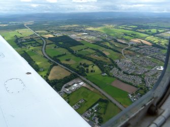 Aerial view of Inshes, Simpsons Garden Centre and A9, on outskirts of Inverness, looking S.