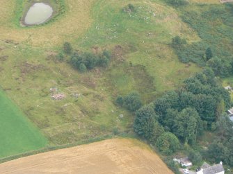 Aerial view of Mulchaich Cairn, Township and corn-drying kiln, Black Isle, under excavation, looking S.