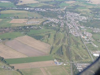 An oblique aerial view of Muir of Ord, Black Isle, looking N.