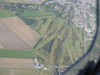 An oblique aerial view of Muir of Ord, Black Isle, looking NNE.