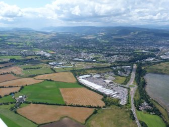 Oblique aerial view of Inverness Retail Park, with Inverness beyond, looking SW.
