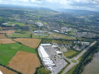 Oblique aerial view of Inverness Retail Park, with Inverness beyond, looking SW.