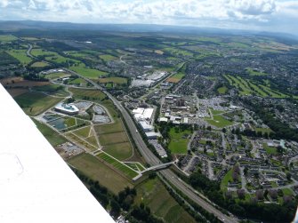 Oblique aerial view of the Beechwood campus, Raigmore Hospital and Inshes Retail Park, Inverness, looking S.