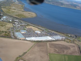 Oblique aerial view of Inverness Retail and Business Park and the former Longman landfill site, looking NW.