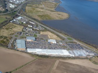 Oblique aerial view of Inverness Retail and Business Park, Raigmore Interchange and the former Longman landfill site, looking NW.