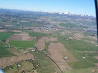 An oblique aerial view of Easter Ross, including the villages of Conon Bridge and Maryburgh, looking NW.