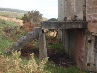 View from the SW of the steps leading up to the landing in front of the two doorways providing access to the upper floor