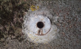 Close-up of a small circular base plate for a pipework balustrade around the NW edge of the gun pit in the Gun Emplacement 