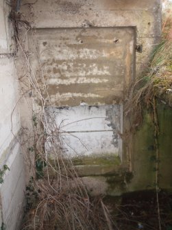 The cupboard opposite in the NW wall opposite the doorway providing access to the compartment in the lower tier at the SE end of the building