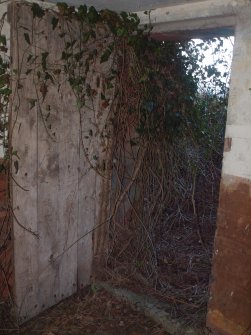 The doorway in the SW wall of the lower compartment of the upper tier at the NE end of the building