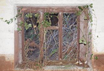 An internal view from the E of the window in the SW wall of the lower compartment, below the upper tier at the NE end of the building