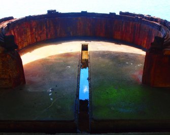 View from the N of the cable channels in the floor and the corroded iron rails for the shuttering on the parapet fronting the housing of the WSW searchlight 