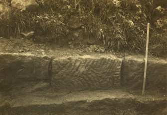 Excavation photograph showing a stone in the wall of Castlecary Roman fort.
